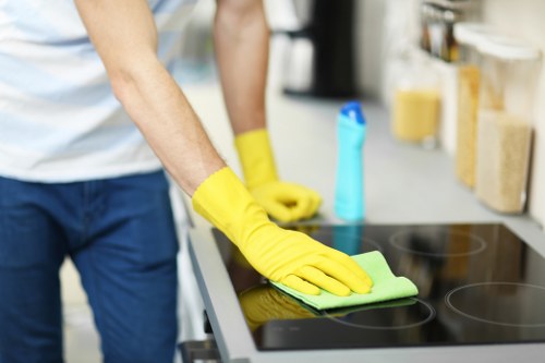 Cleaner using PPE during a professional carpet cleaning job